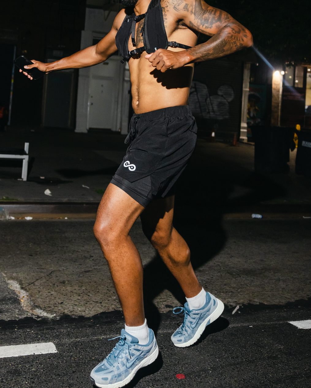 Runner in See No Limits 2-in-1 Performance Running Shorts on a city street at night